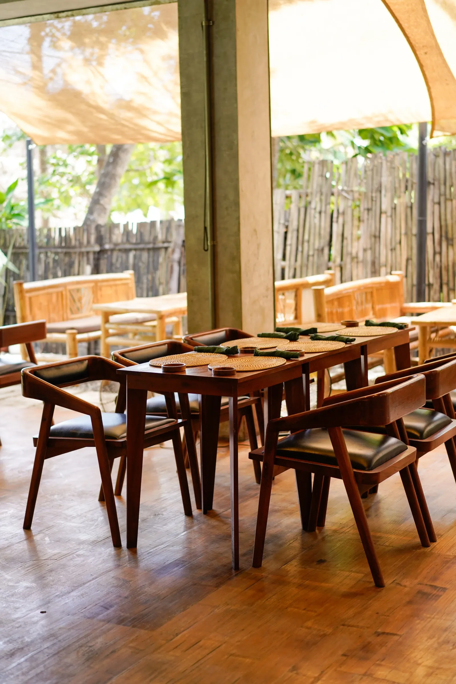 The open-air dining area with wooden tables at Anahaw Dauin