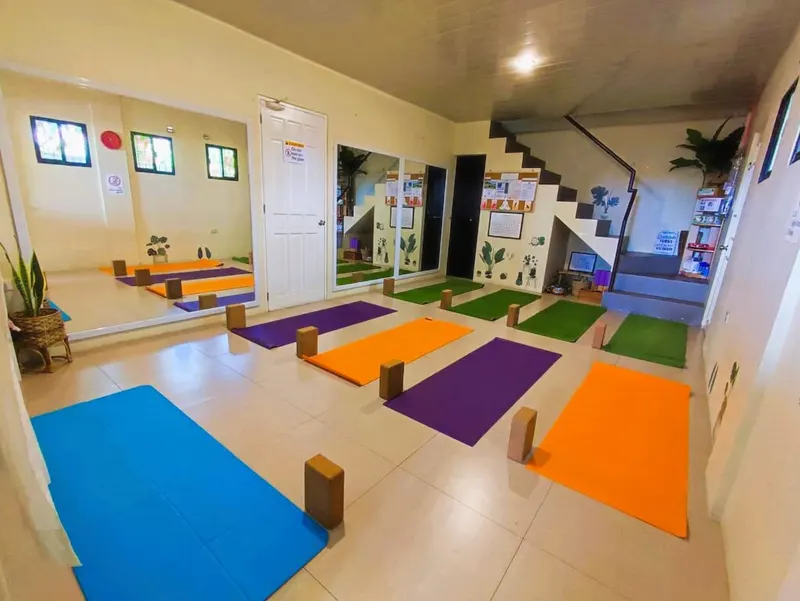 The practice room at Ann Yoga Studio with colourful mats and blocks laid out