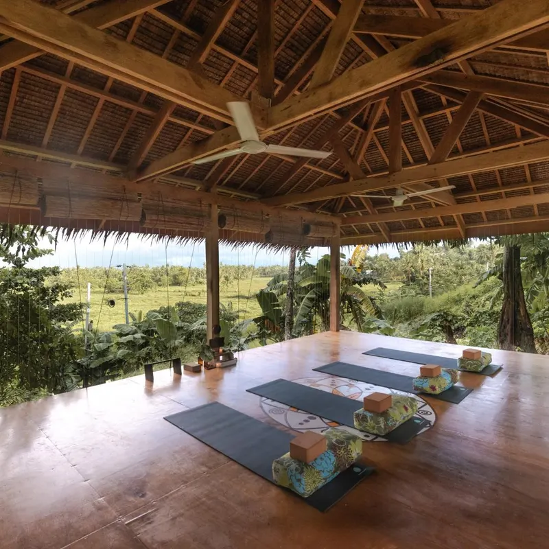 The open-air wooden shala at Bodhi Yoga Center Siargao with mats, blocks and bolsters laid out