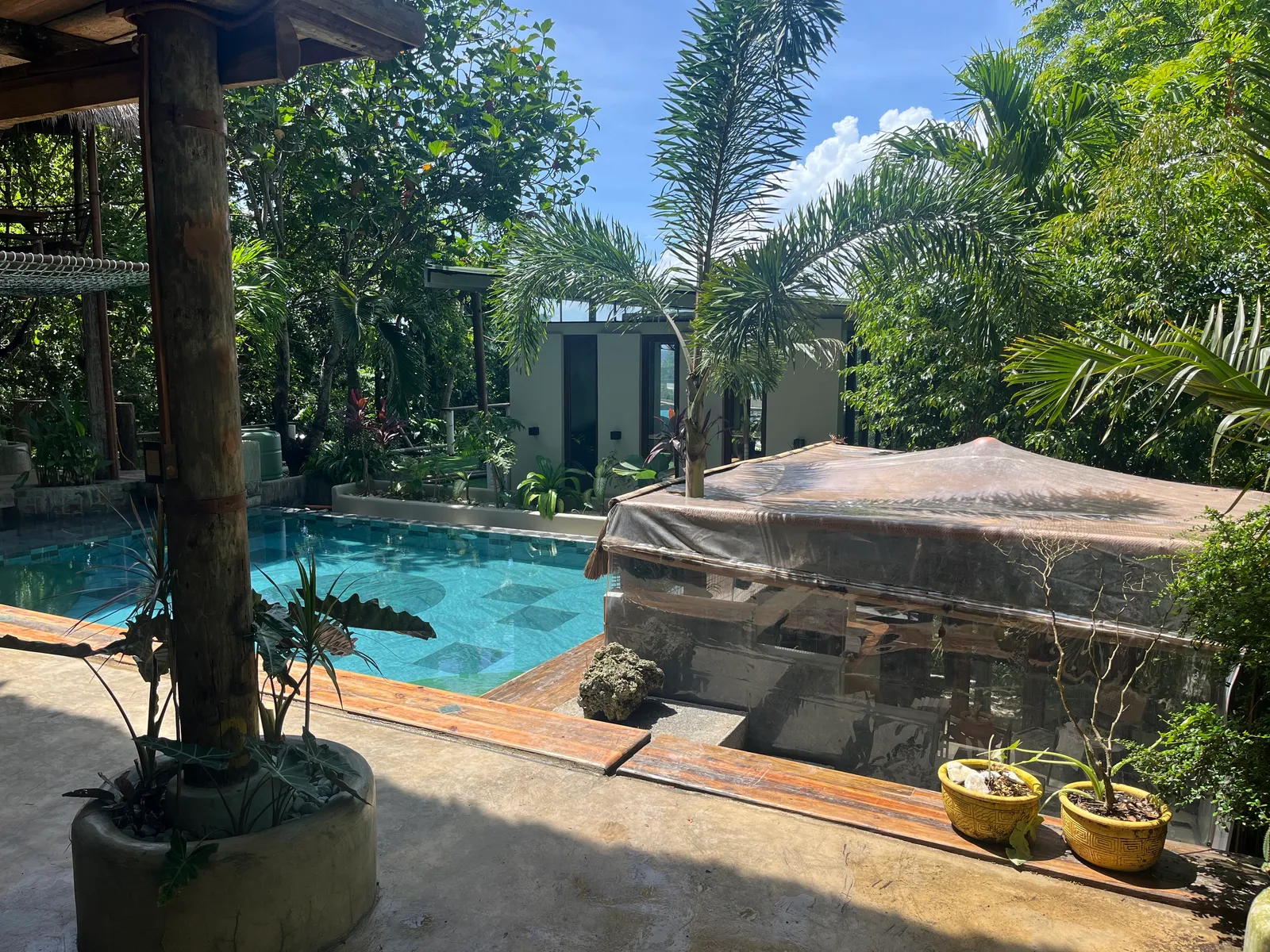 The pool and tropical garden at Calma Home Boracay