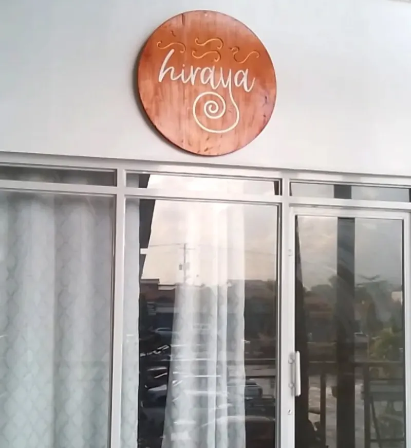 The round Hiraya sign above the sliding window of the studio at Hiraya Wellness