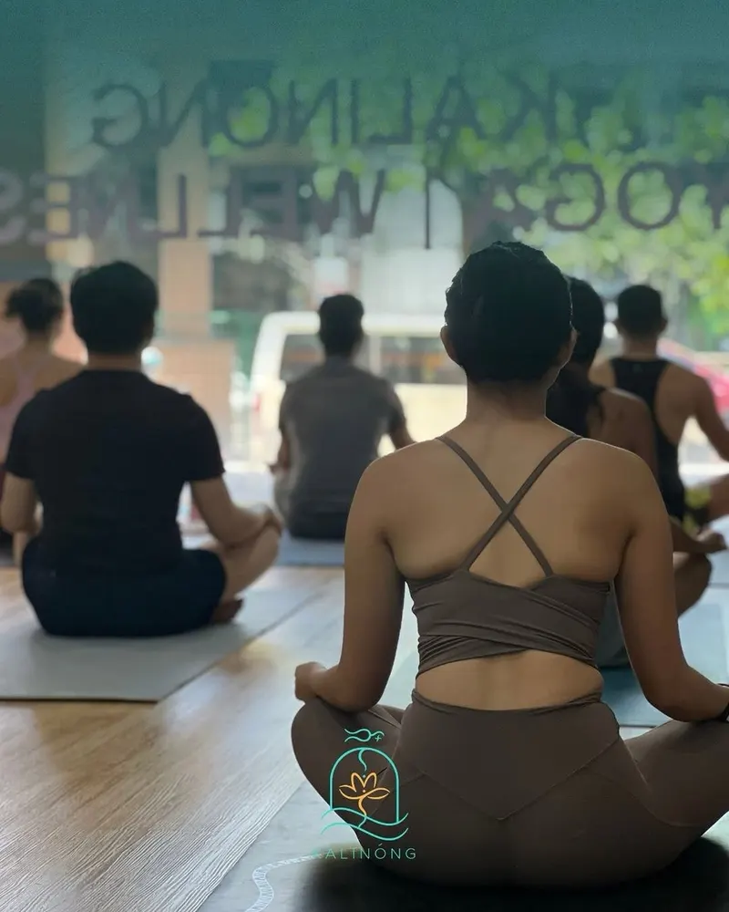 A Kalinong Wellness class seated in meditation, seen from behind