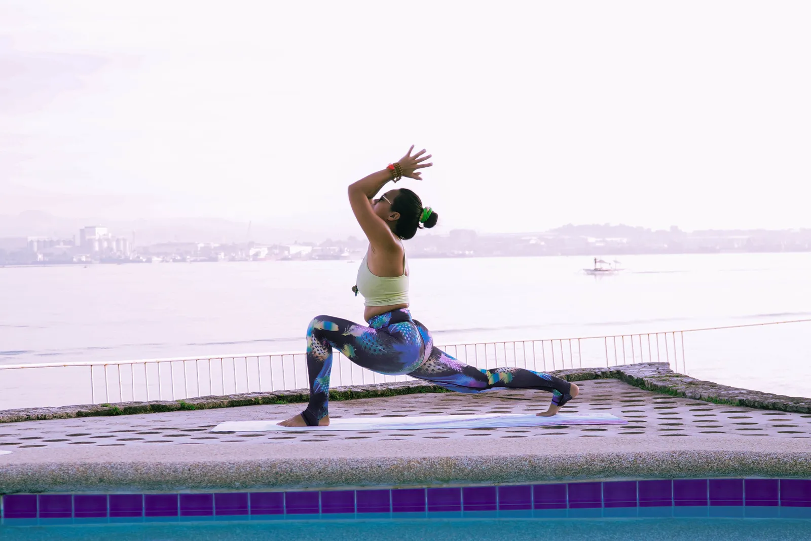 Practitioner in a lunge on a seaside terrace