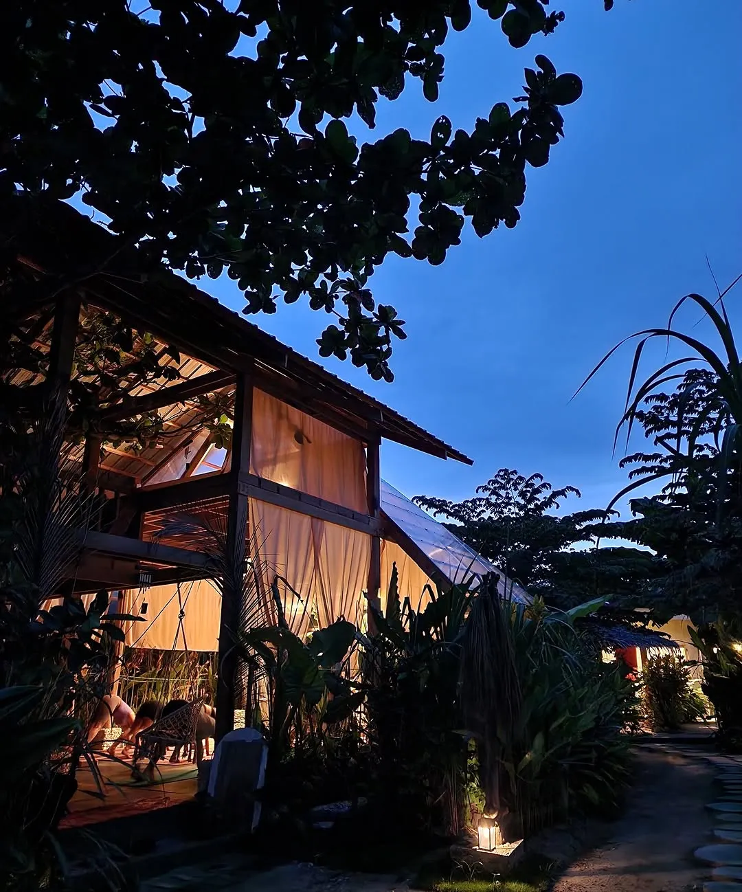 Garden buildings lit up at dusk