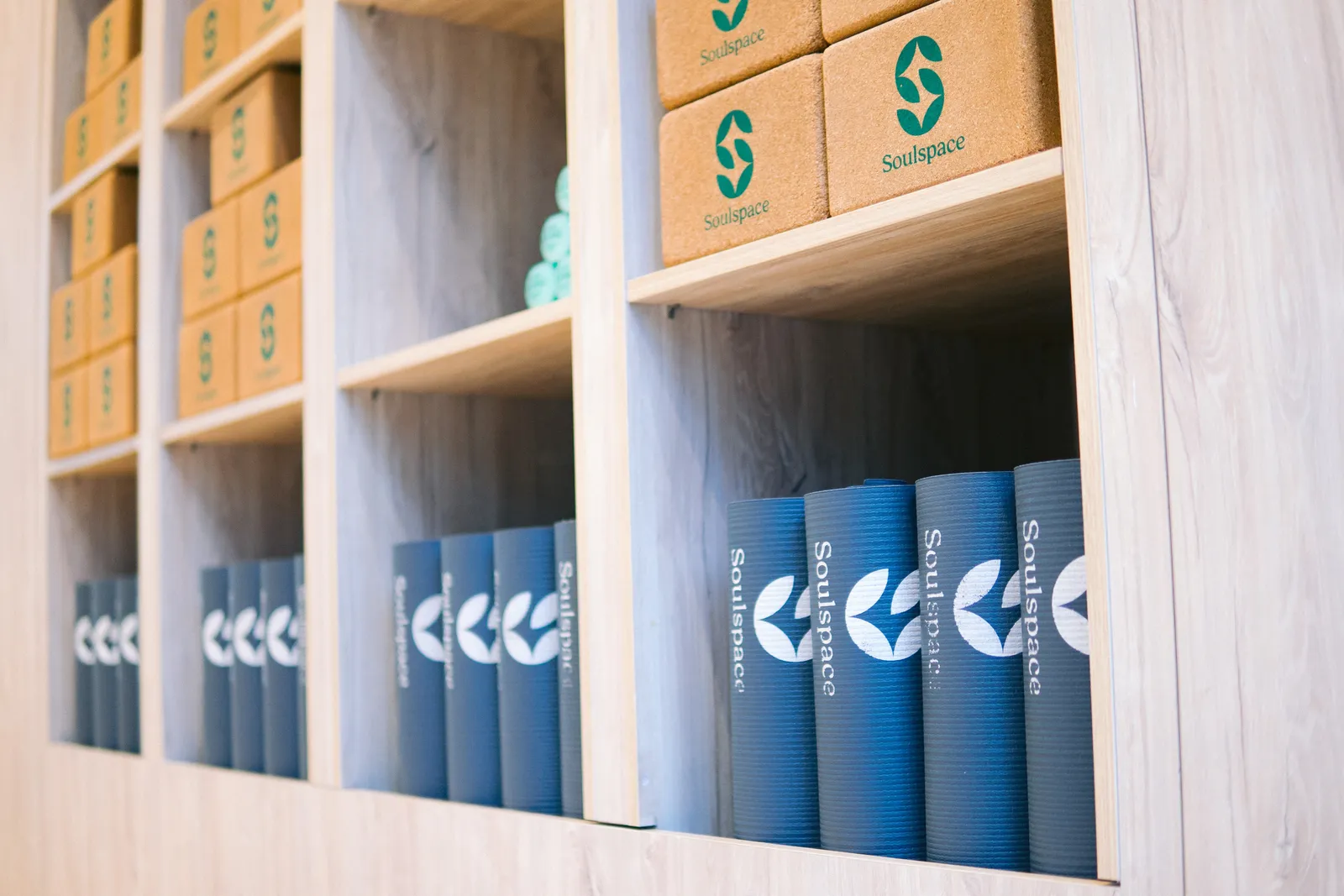 Wooden shelves stacked with branded cork blocks and bolsters