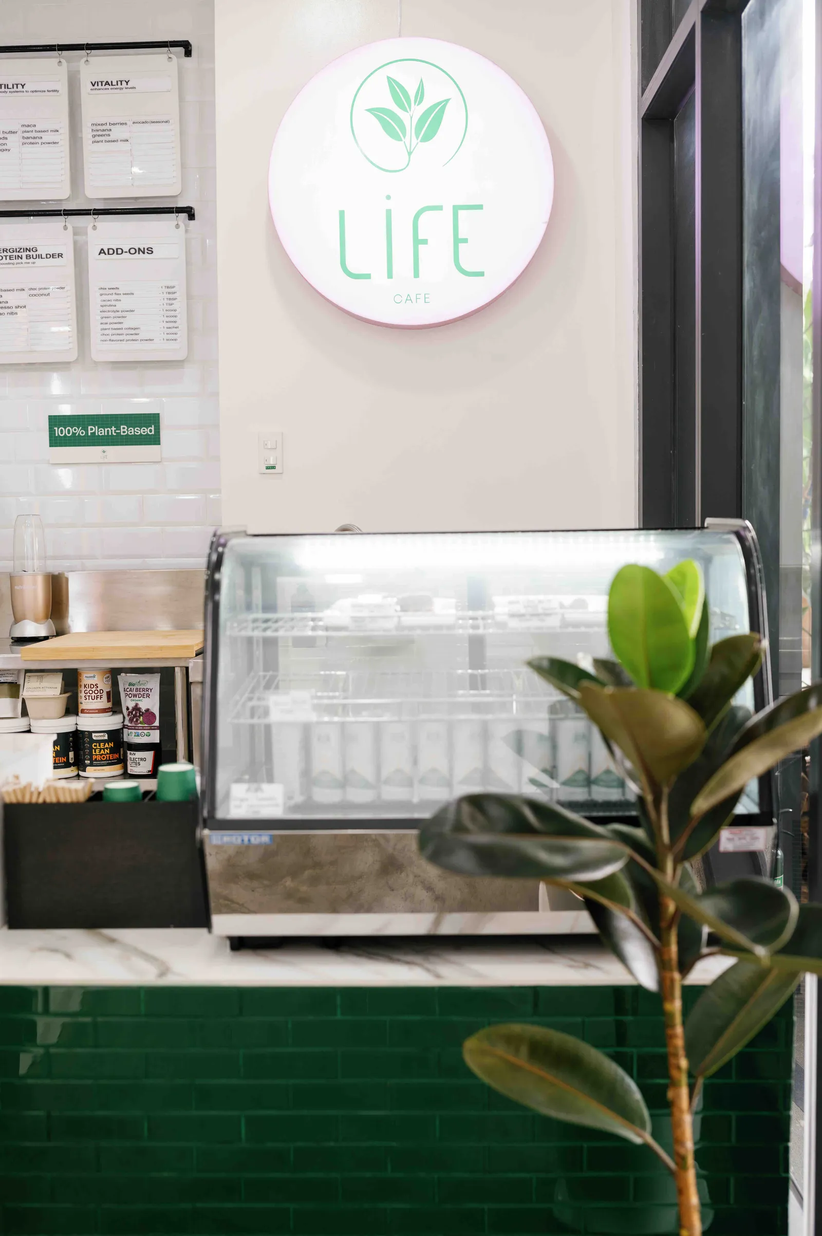 Juice bar counter with a glass display case and a round LIFE sign