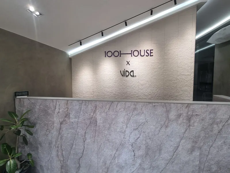 Reception counter in marble-effect stone with the studio sign on the wall